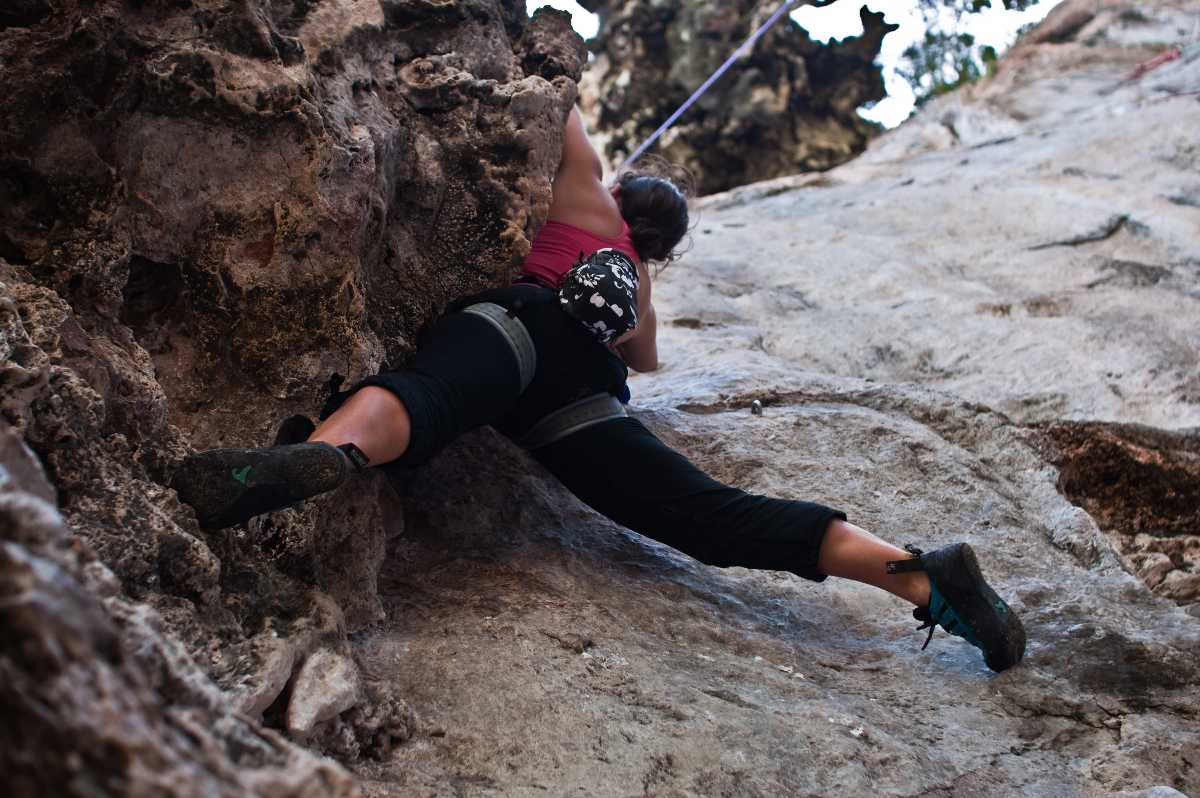 Beautiful athletic woman rock climbing wearing nothing but a bikini with  harness and climbing shoes - Playground